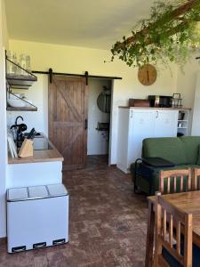 a living room with a wooden door and a couch at Ubytování u Kotrbů in Suchdol nad Lužnicí
