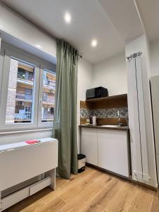 a kitchen with a counter and a sink and a window at The Family Rooms, Rione alto, Zona ospedaliera in Naples +43 photos