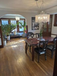 a dining room with a table and chairs and a chandelier at Updated cozy in central Cleveland in Cleveland