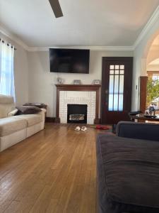 a living room with a couch and a fireplace at Updated cozy in central Cleveland in Cleveland