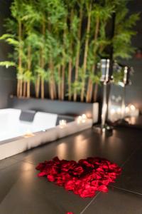 a pile of red rose petals on a table at B Suite Spa in Palermo