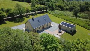 an aerial view of a house with a solar roof at Lissyclearig Lodge in Kenmare