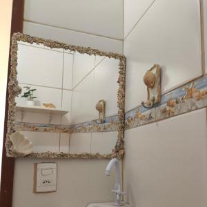 a bathroom with a mirror and a sink at Aconchego das Conchas in Mangaratiba +114 photos