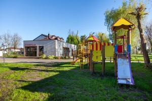 a group of playground equipment in a park at Przyczepa campingowa in Grzybowo