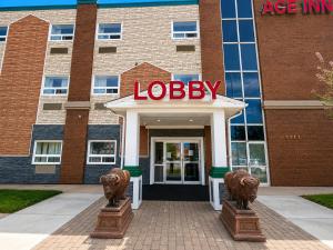 a building with a jobbie sign in front of it at Ace Inn in Fort McMurray