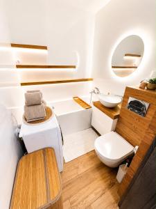 a bathroom with a toilet and a sink at Exclusive Apartament Centrum 45m in Tarnów