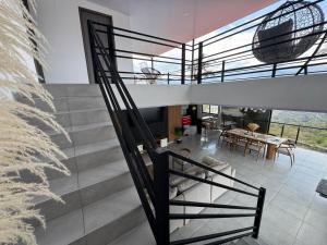 a spiral staircase in a house with a dining room at House premium in Macanal