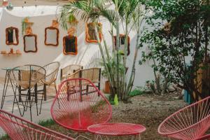 a group of chairs and tables in a yard at Casa de Rosa in Puerto Escondido