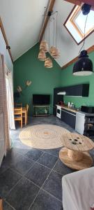 a living room with a table in the middle of a room at Les Limousines - Proche de Pairi Daiza, Mons, Soignies in Soignies