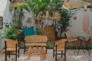 a patio with chairs and a table and a table and chairs at Casa de Rosa in Puerto Escondido
