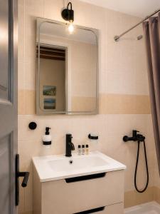 a bathroom with a sink and a mirror at Athina Guesthouse in Hydra +129 photos