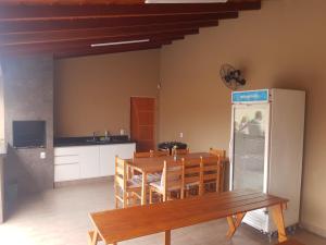 a dining room with a table and a refrigerator at quiet corner in Sao Jose do Rio Preto
