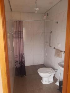 a small bathroom with a toilet and a shower at quiet corner in Sao Jose do Rio Preto