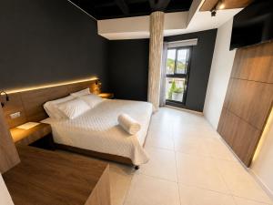 a bedroom with a bed and a large window at Hotel La Leonelda in Ocaña +7 photos