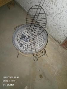 a metal bird cage sitting on a concrete floor at Dar MORTADA TATAOUINE in Tataouine