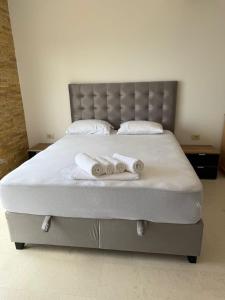 a bed with two towels on top of it at Luxury Villa Pontus in Kotor +34 photos