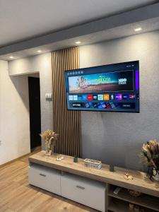 a flat screen tv on the wall of a room at A&A Apartment in Sarajevo