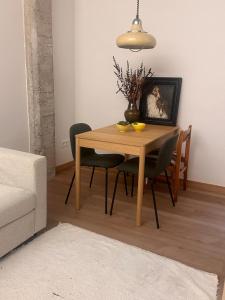 a dining room with a wooden table and chairs at Central Bilbao, 3min walk to Guggenheim with AC in Bilbao