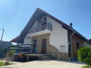 a small white house with a brown roof at Plitvice Fairytale1 in Jezerce