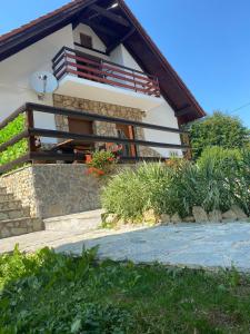 a house with a balcony on the side of it at Plitvice Fairytale1 in Jezerce