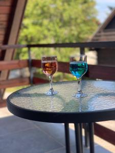 two wine glasses sitting on top of a table at Plitvice Fairytale1 in Jezerce