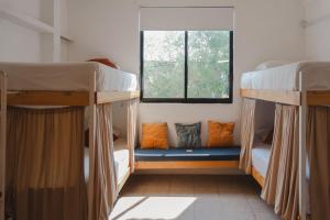 two bunk beds in a room with a window at Casa de Rosa in Puerto Escondido +18 photos