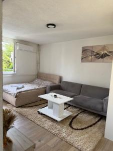 a living room with a couch and a table at A&A Apartment in Sarajevo