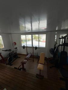 a gym with exercise equipment in a room with a window at Villa San Miguel in San Andrés