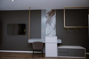 a room with a white desk and a chair at Villa 100 Boutique Pogradec in Pogradec