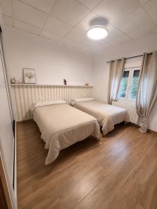 two beds in a room with wooden floors at Mirador de Molinicos in Molinicos +21 photos
