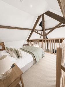 a bedroom with a bed and a table at The Raven Suites in Much Wenlock