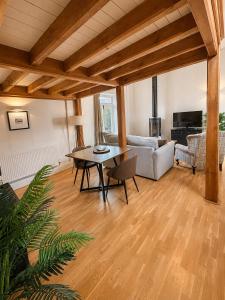 a living room with a table and a couch at The Raven Suites in Much Wenlock