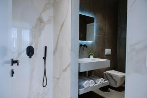 a bathroom with a sink and a mirror at Villa 100 Boutique Pogradec in Pogradec