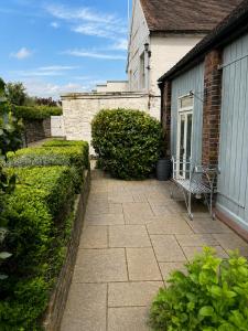 a chair sitting on a patio outside of a house at The Raven Suites in Much Wenlock