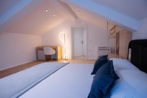 a bedroom with a large white bed and a desk at Villa 100 Boutique Pogradec in Pogradec
