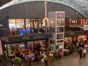 a group of people walking around a shopping mall at Glasgow City Center Flat with Parking in Glasgow