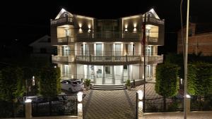 a building with a car parked in front of it at Villa 100 Boutique Pogradec in Pogradec