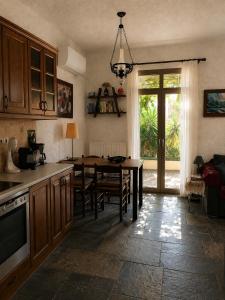 a kitchen with a table and a dining room at Billy's Place in Egina