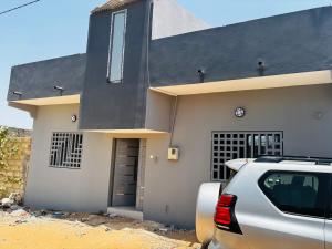 a car parked in front of a house at Villa Diamaguene in Ngaparou