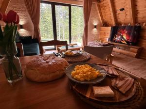 a table with food on top of it with a fireplace at Villa Aleksandra in Žabljak