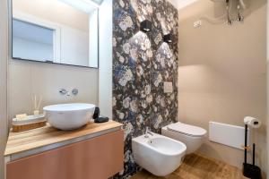 a bathroom with a sink and a toilet at Deiana's House in Alghero +27 photos