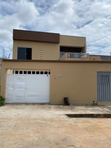 a house with two garage doors in front of it at Apartamento no Crato, conforto e praticidade! in Crato