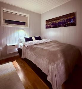 a bedroom with a large bed in a room at Villa Storvoll - Fjord & Mountain View in Lyngen