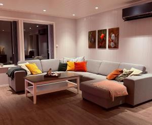 a living room with a couch and a table at Villa Storvoll - Fjord & Mountain View in Lyngen