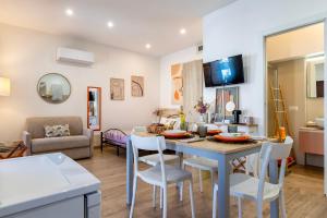 a kitchen and living room with a table and chairs at Deiana's House in Alghero