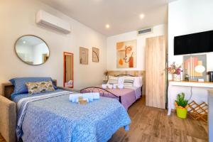 a living room with two beds and a couch at Deiana's House in Alghero
