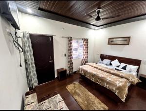 a bedroom with two beds in a room at Kedar velley in Phata +3 photos