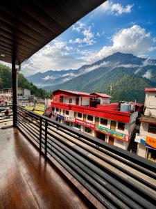 a view from the balcony of a building with mountains in the background at Kedar velley in Phata