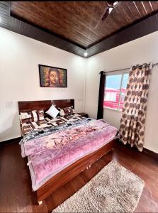 a bedroom with a large bed and a window at Kedar velley in Phata