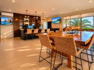 a dining room with a large wooden table and chairs at Casa Vista 133 in Cabo San Lucas